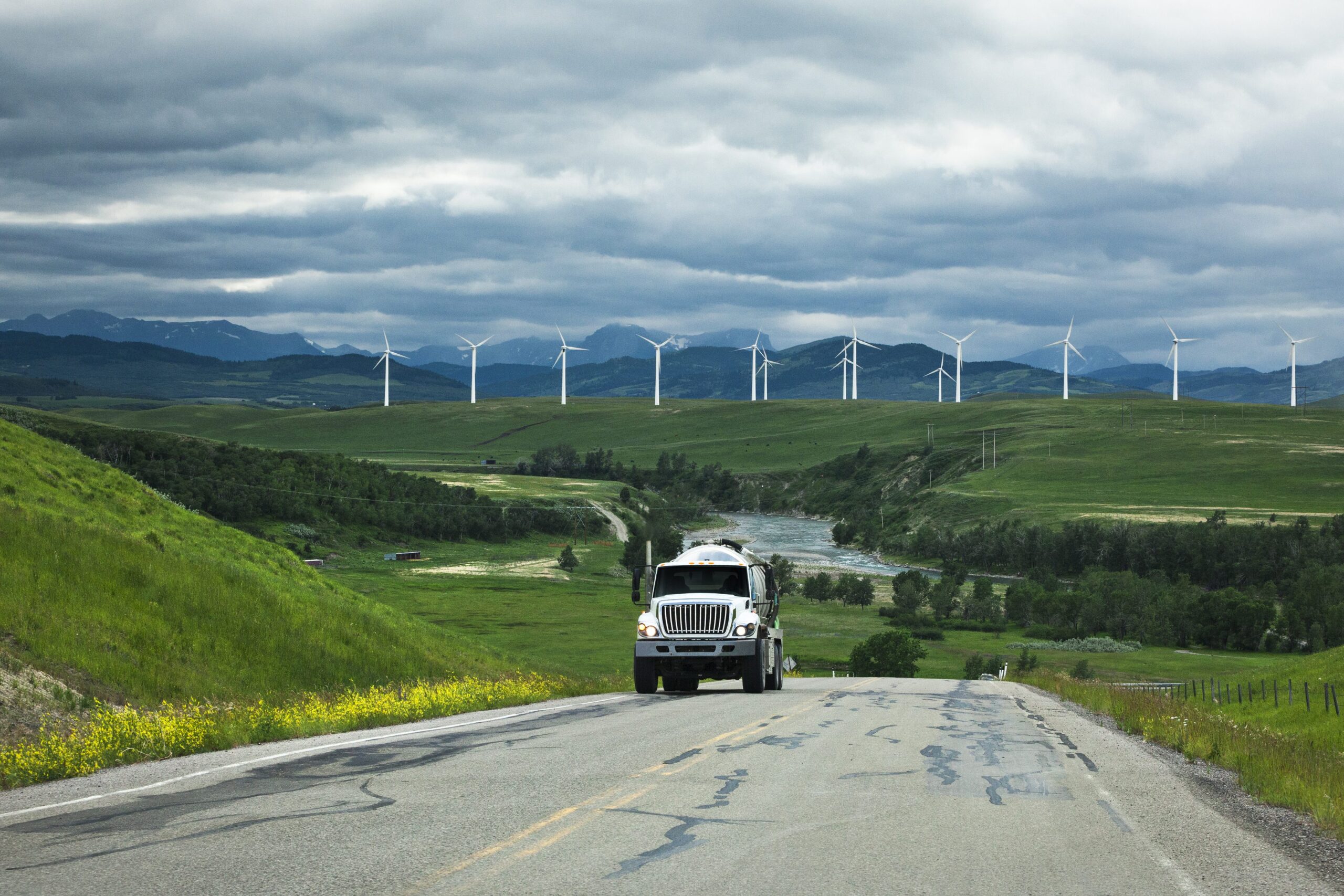 Truck Driving by Wind Farm in the Canadian Rocky Mountains of Alberta, Canada